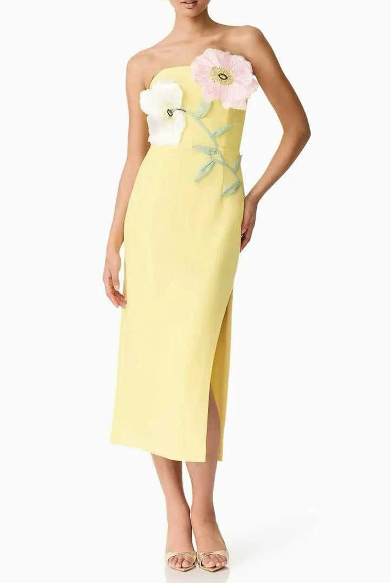 Yellow strapless dress with floral embellishments on a white background