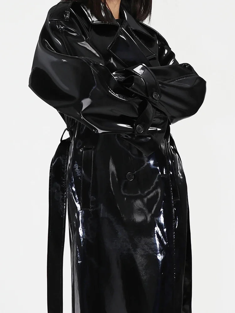 Black glossy trench coat on a white background