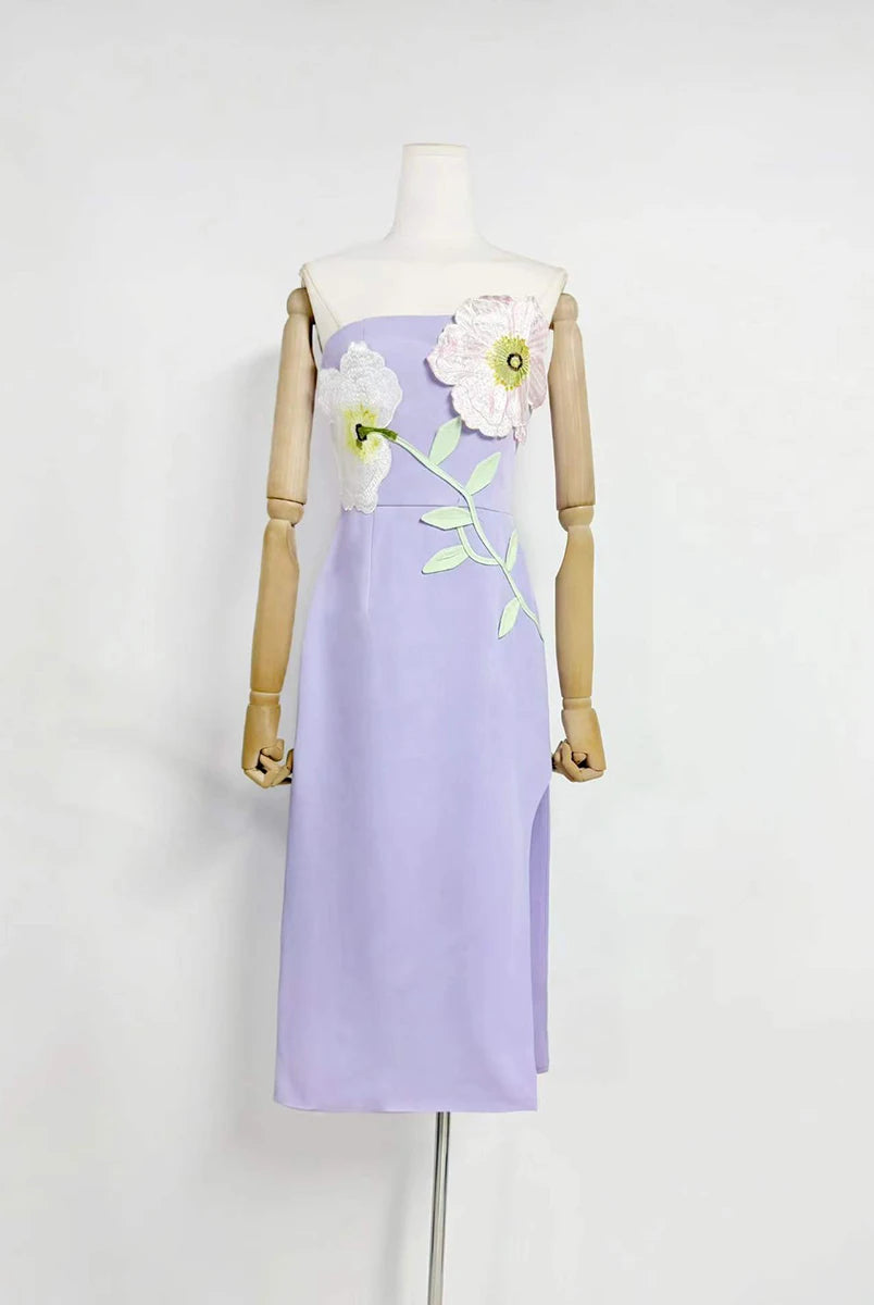 Lavender dress with floral embroidery on a mannequin against a white background