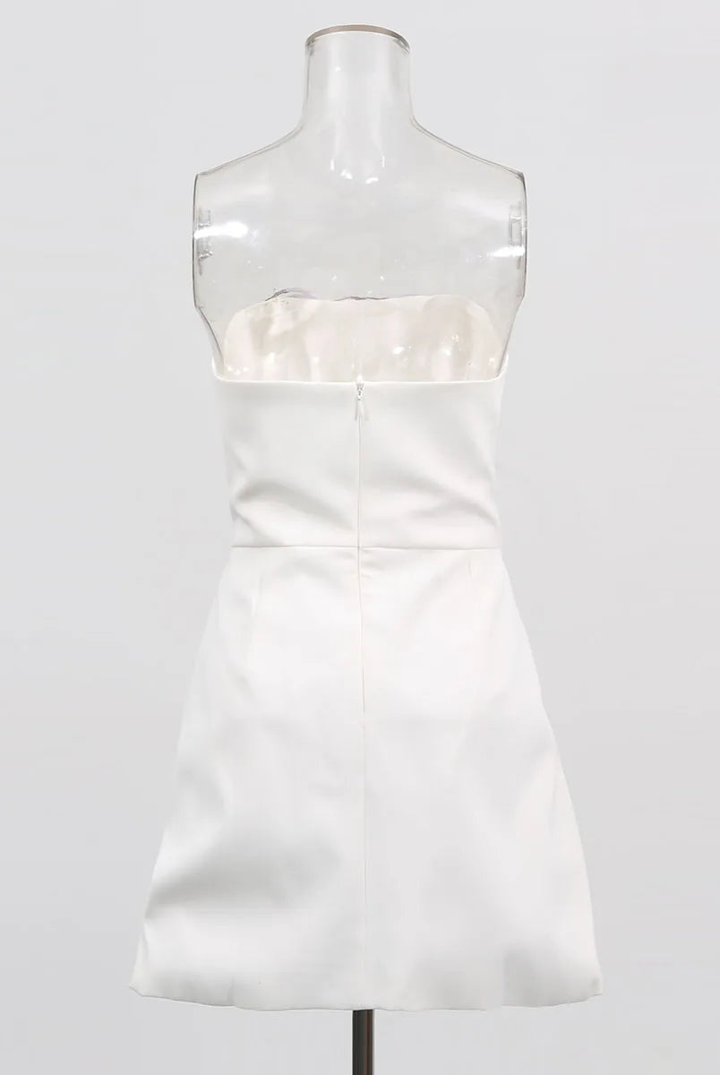 White strapless dress on a mannequin against a white background