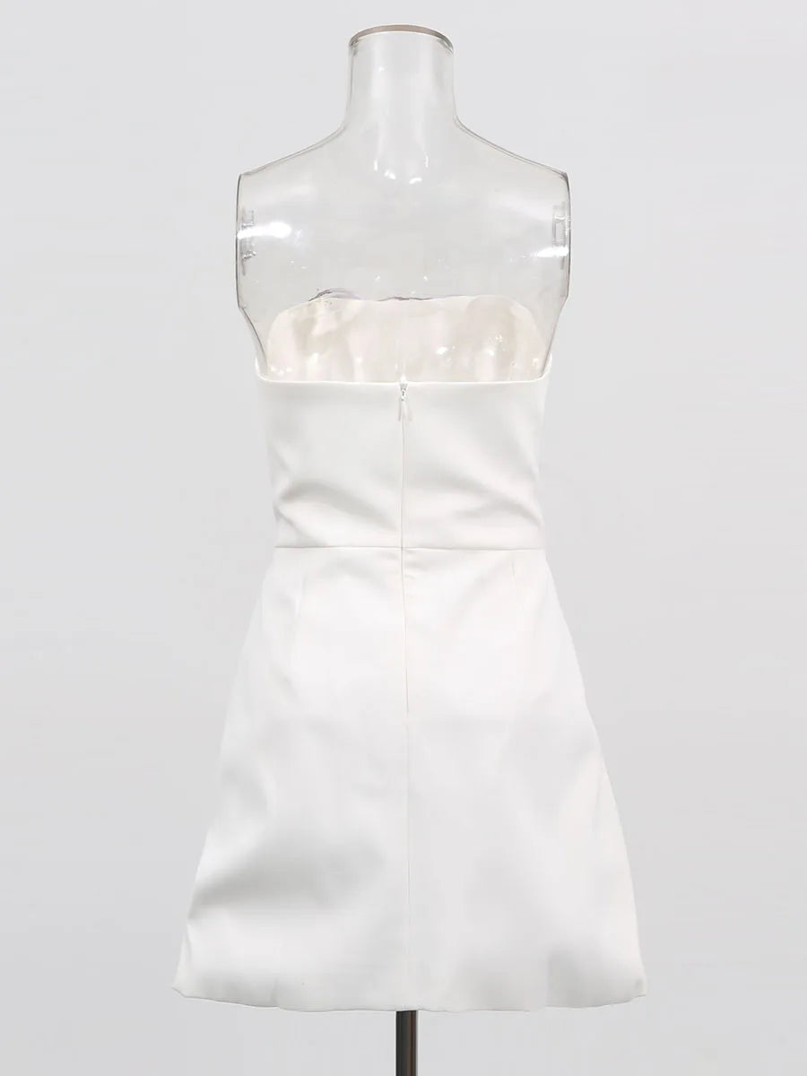White strapless dress on a mannequin against a white background