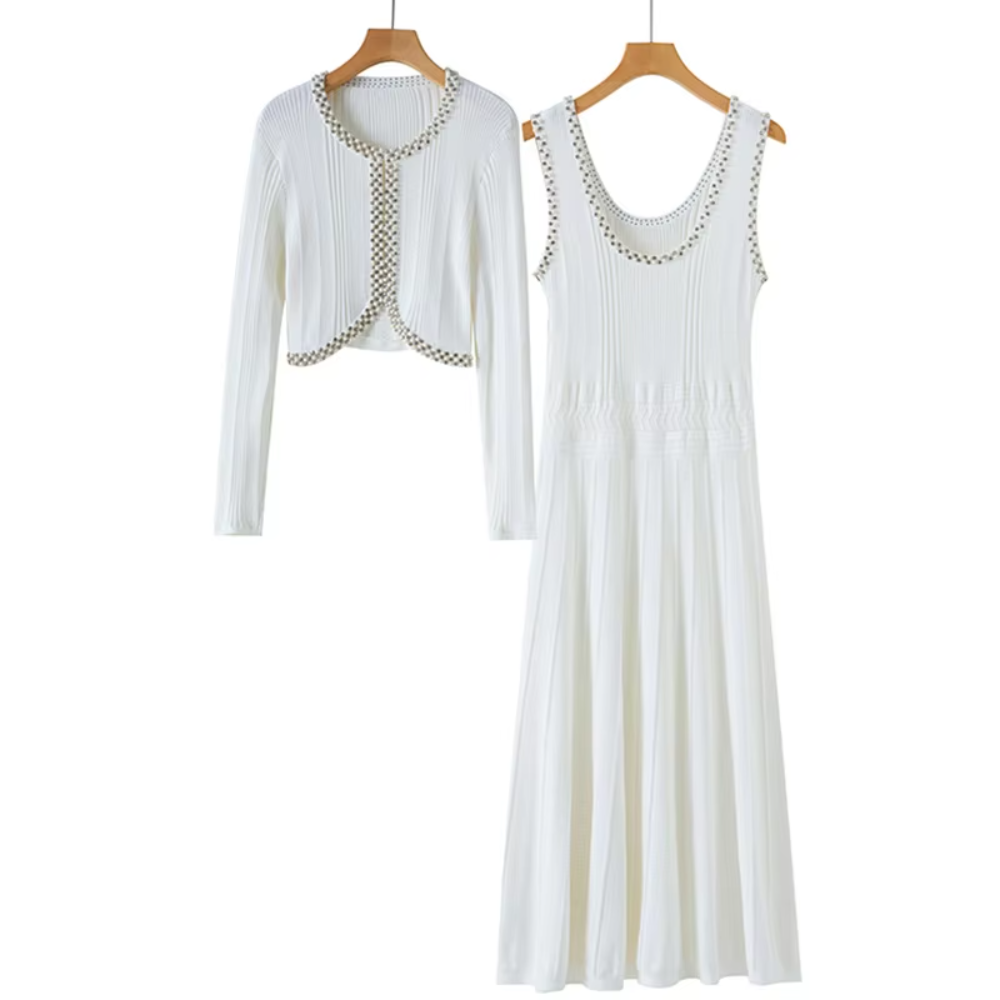 A matching two-piece women's outfit set hanging on wooden hangers against a plain white background. The set includes a sleeveless white ribbed maxi dress with decorative beaded trim along the scoop neckline and a matching cropped open-front cardigan with long sleeves and beaded trim along the edges.