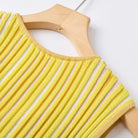 A close-up of a yellow ribbed knit sleeveless top draped over a light wood hanger against a plain white background.