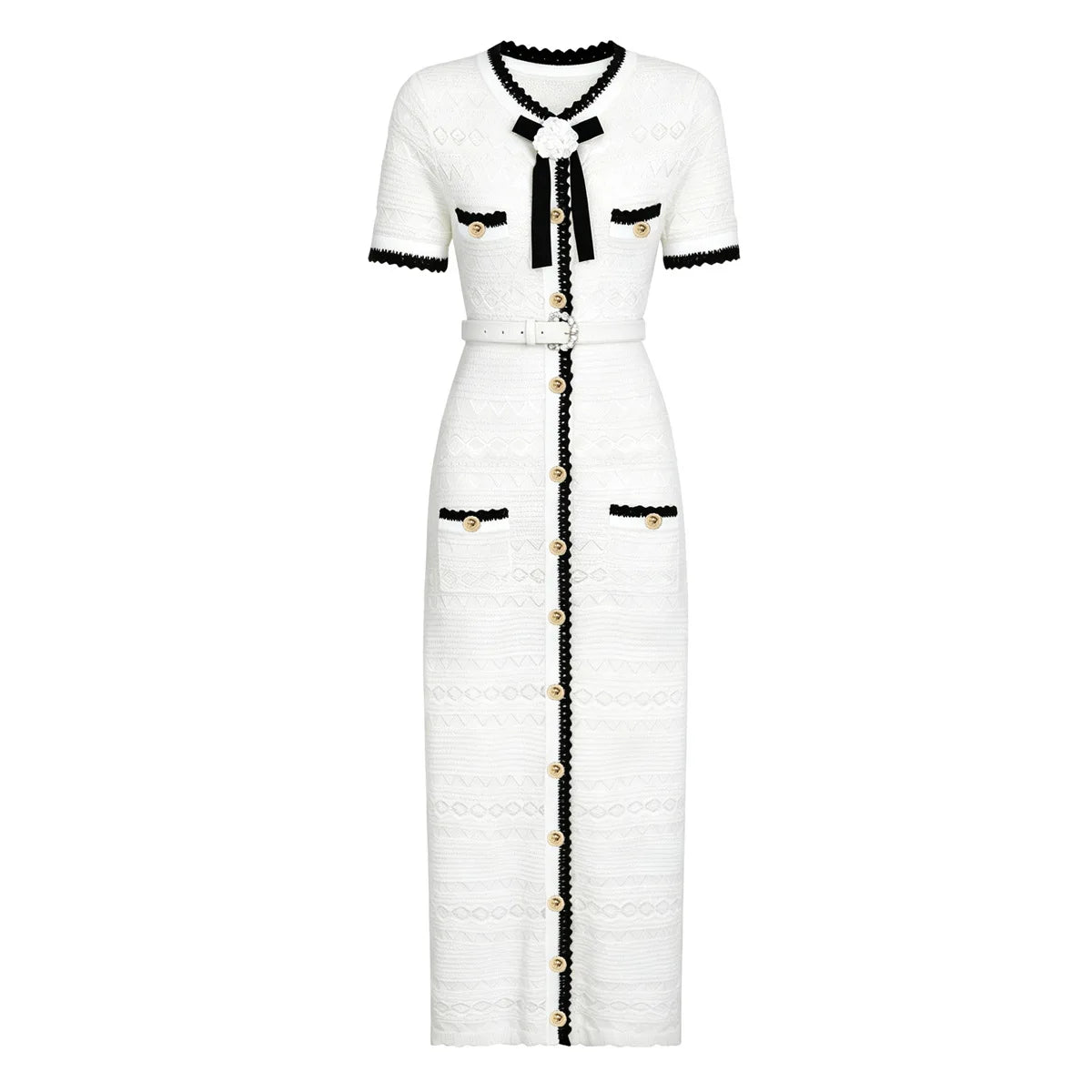 A white tweed midi dress with black trim and gold-tone accents, featuring short sleeves, a black bow at the collar, and a front button closure.