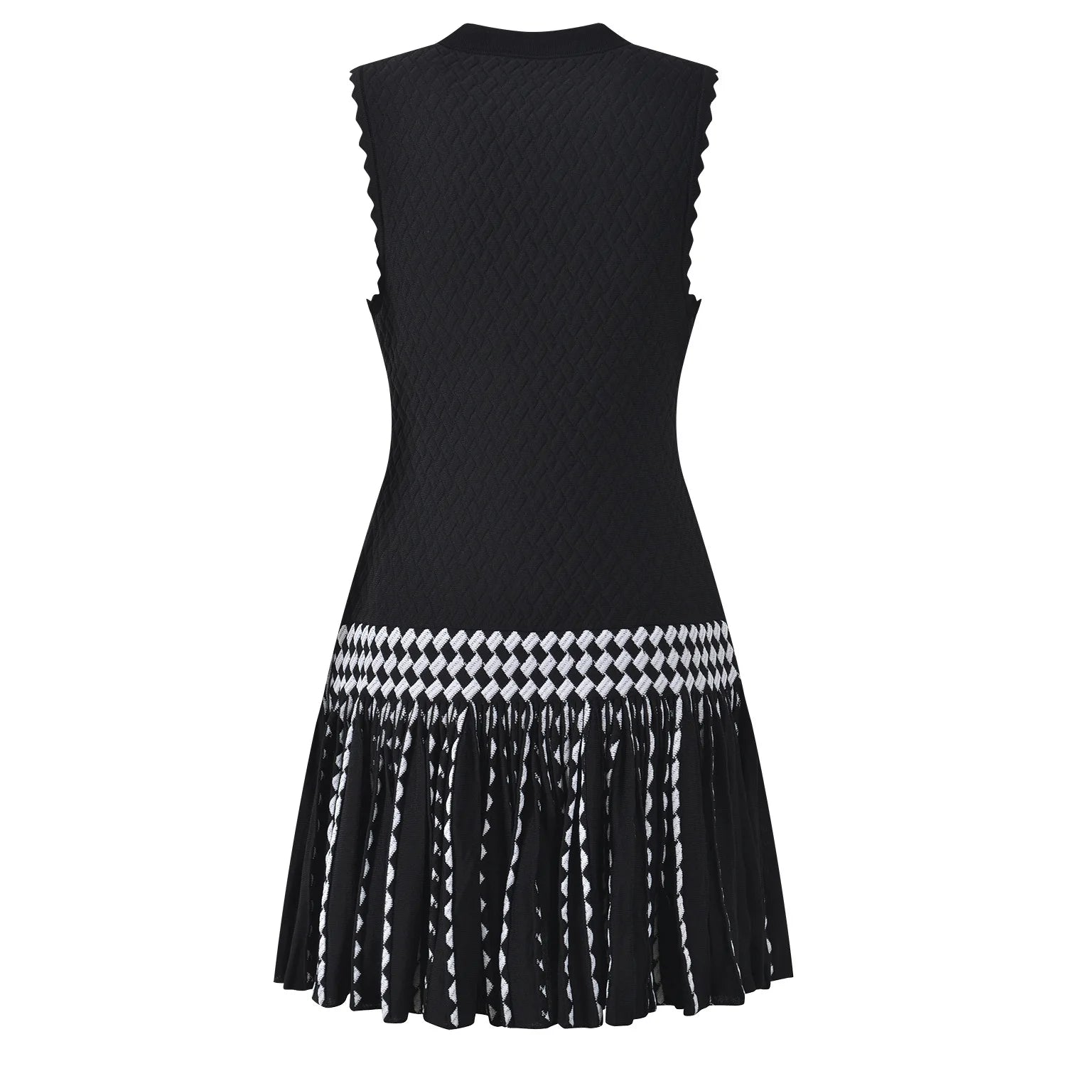 A sleeveless black knit dress with a textured body, scalloped edges, and a flared pleated skirt featuring a black and white geometric pattern and fringe.
