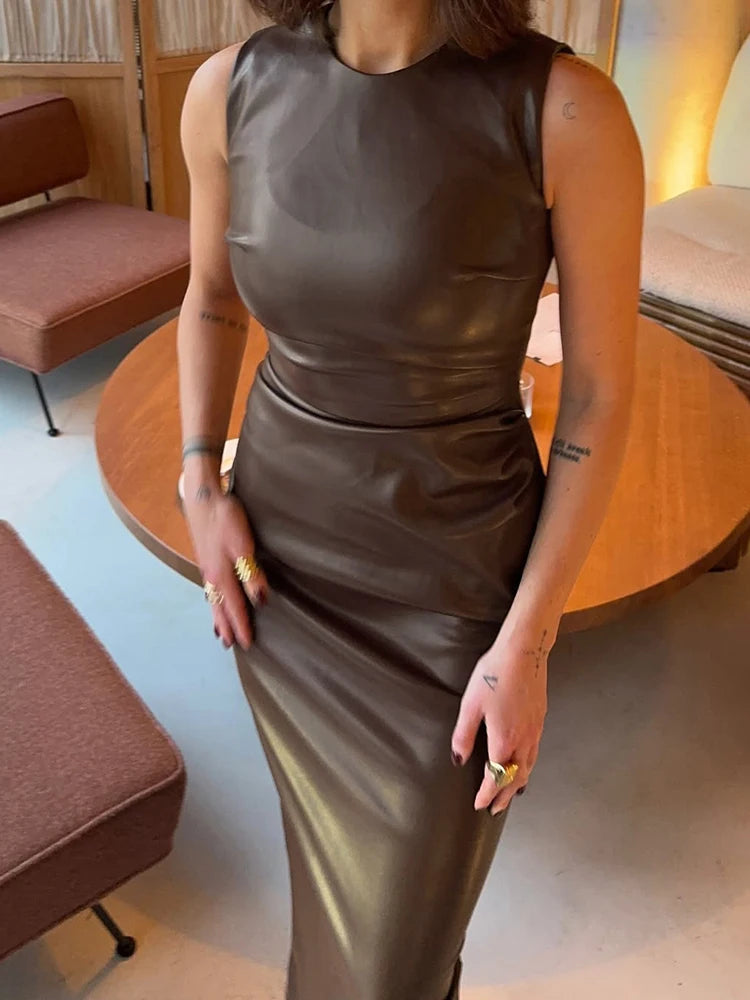 Woman wearing a sleeveless brown ruched faux leather bodycon dress