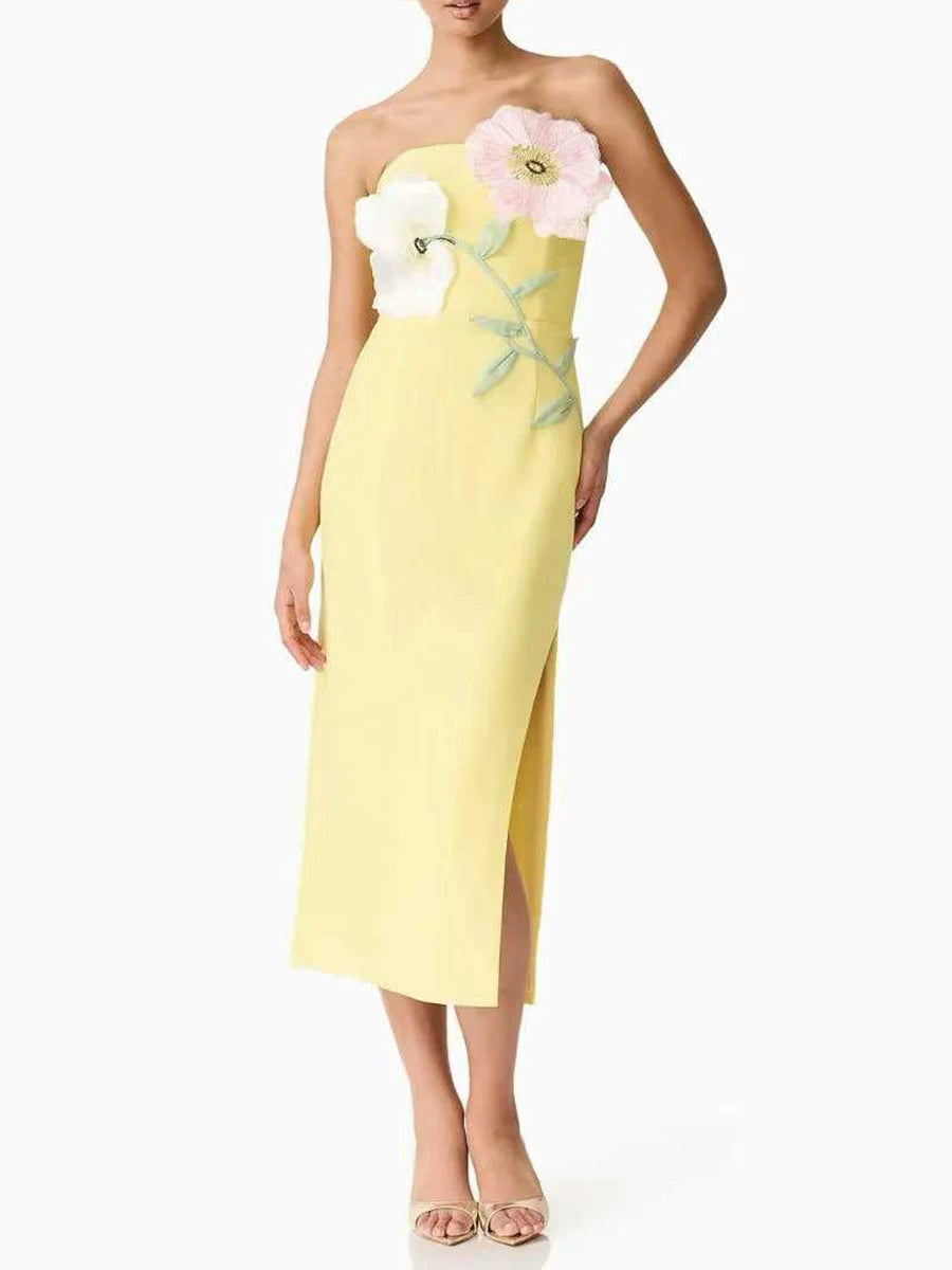 Yellow strapless dress with floral embellishments on a white background