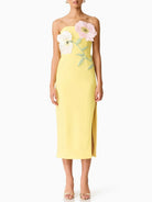 Yellow strapless dress with floral embellishments on a white background