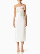 White strapless dress with floral embroidery on a white background