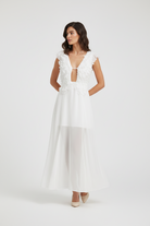 Woman wearing a white floral dress from Trend4us