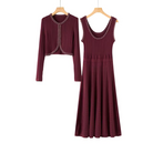 A two-piece women's outfit set in a deep burgundy color, featuring a long-sleeve cropped cardigan with decorative silver chain trim and a matching sleeveless midi dress with a scoop neckline and embellished shoulder straps, shown hanging on wooden hangers against a plain white background.